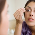 Woman Plucking Eyebrows