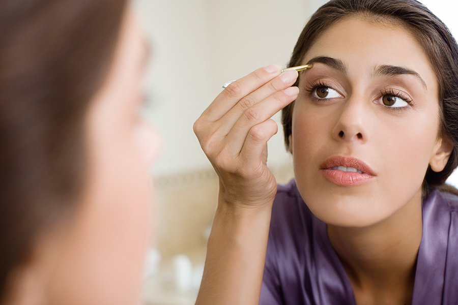 Woman Plucking Eyebrows